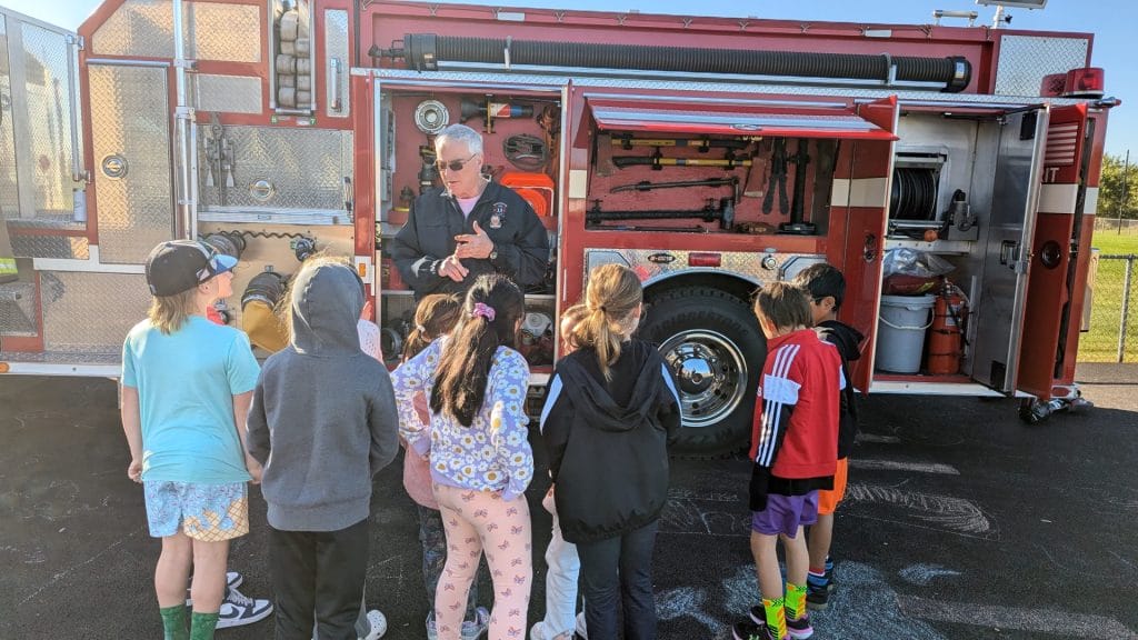 Students standing by fire truck