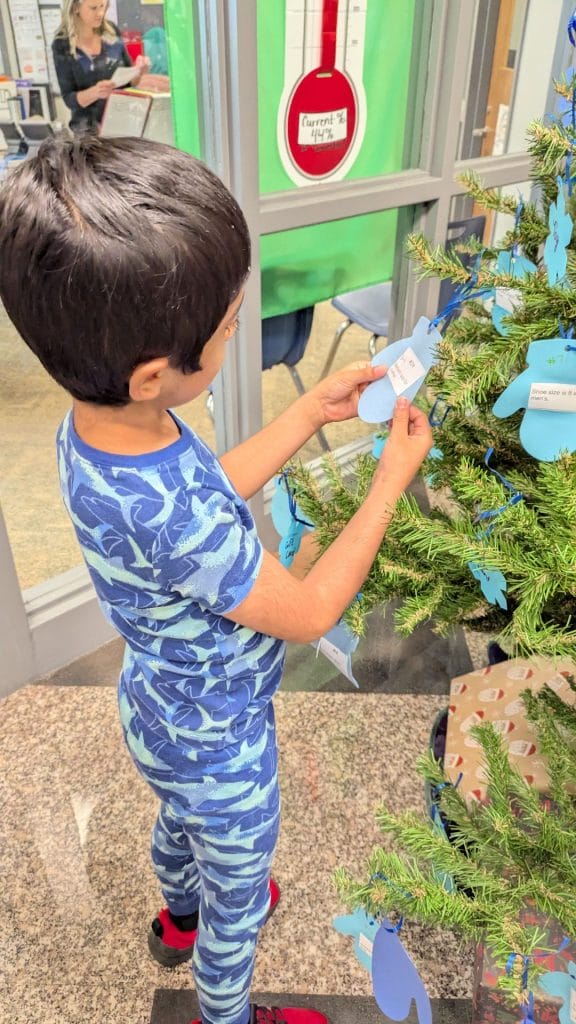 Boy taking tag off of tree