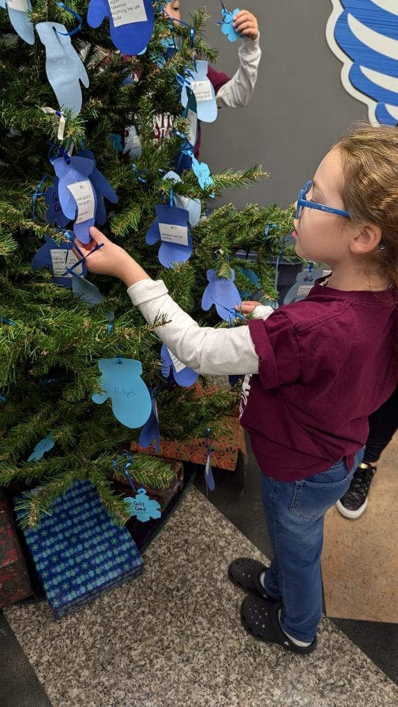 Girl taking tag off of tree