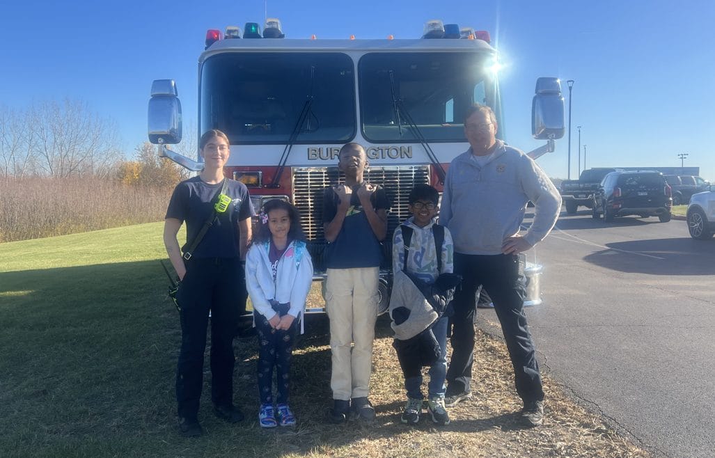 Students standing in front of a fire truck