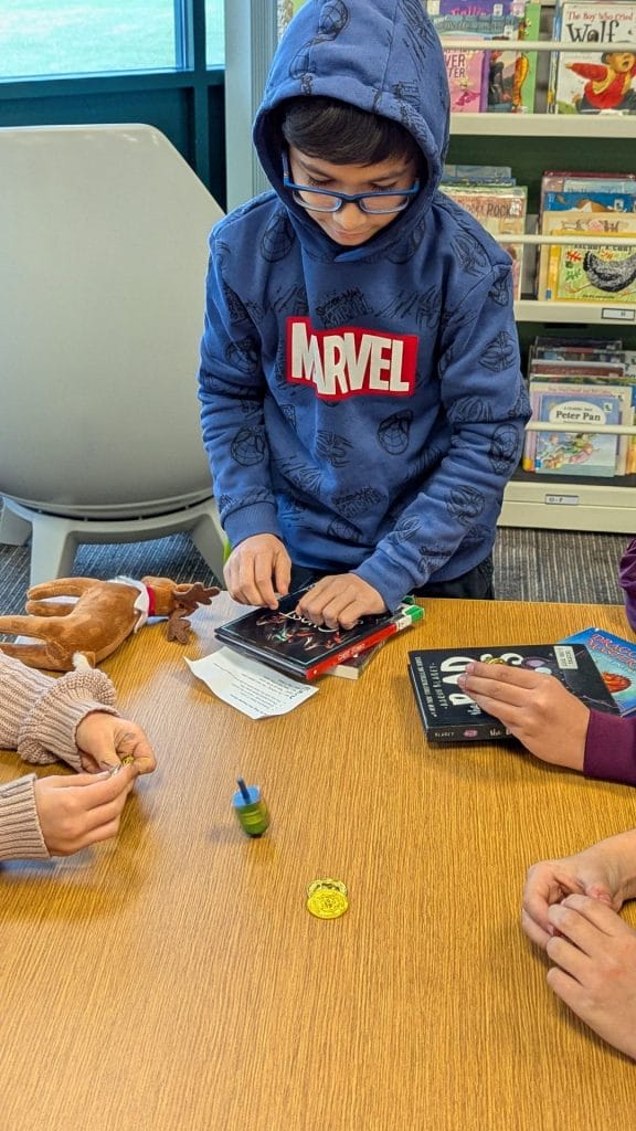 Student watching the dreidel spinning