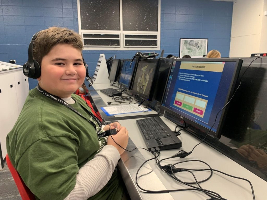 Student in front of control station at Challenger