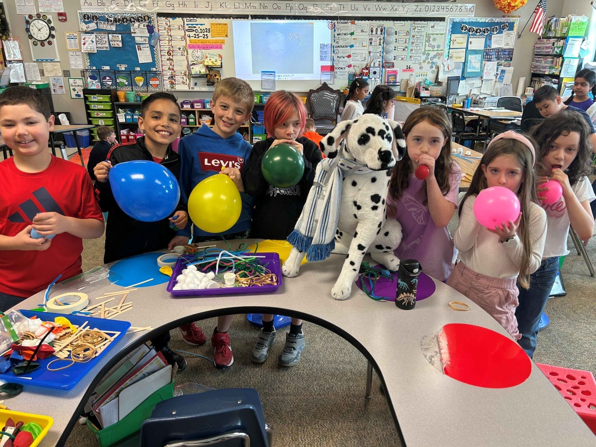 2nd graders blowing up balloons