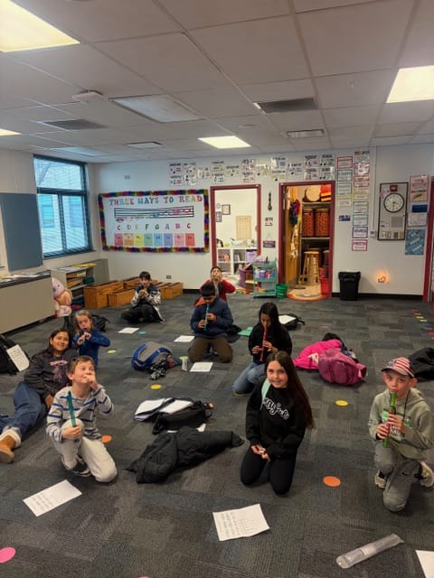 students in music practicing the recorder